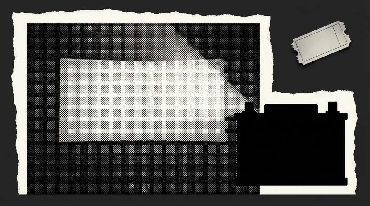 A cinema screen going dark beside a car battery silhouette
