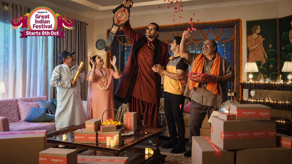 The Great Khali raising a championship belt among a cheering family and a delivery partner, in Amazon’s Great Indian Festival key visual