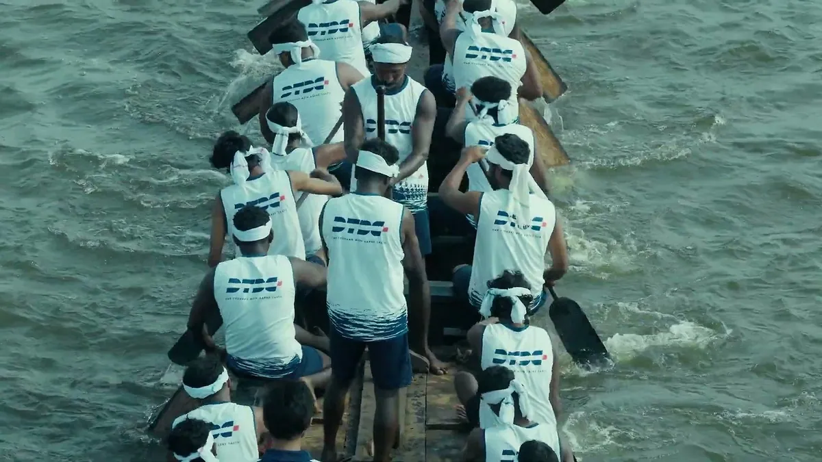 A still from the DTDC Vallam Express film showing a Kerala snake boat crew