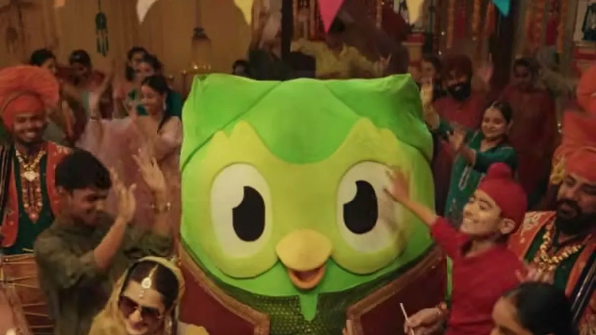 Duolingo's owl mascot Duo dancing in a Punjabi celebration in the Ullu Da Pattha campaign film
