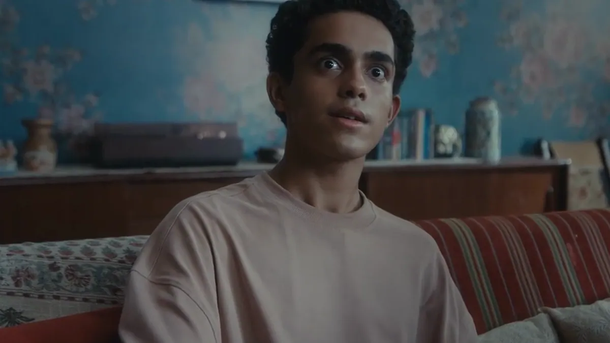 A young man on a sofa mid-conversation, from the Flipkart Big Billion Days film about buying a television one size bigger
