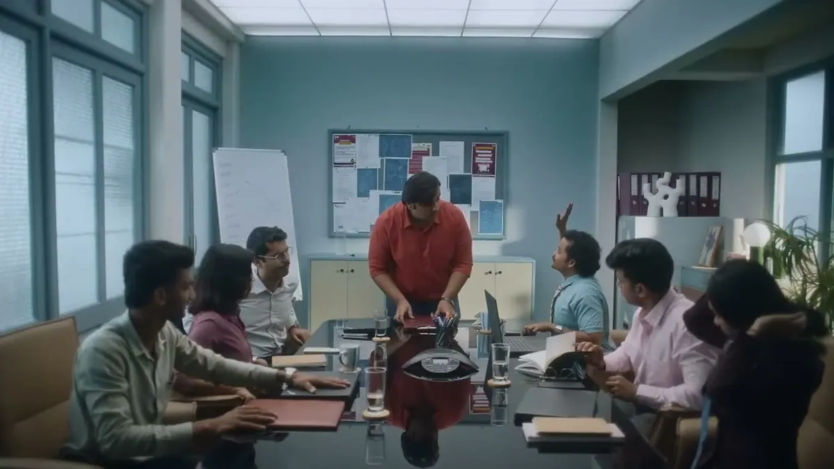 A still from the Flipkart Hire A Rakhi Reminder campaign film set in an office
