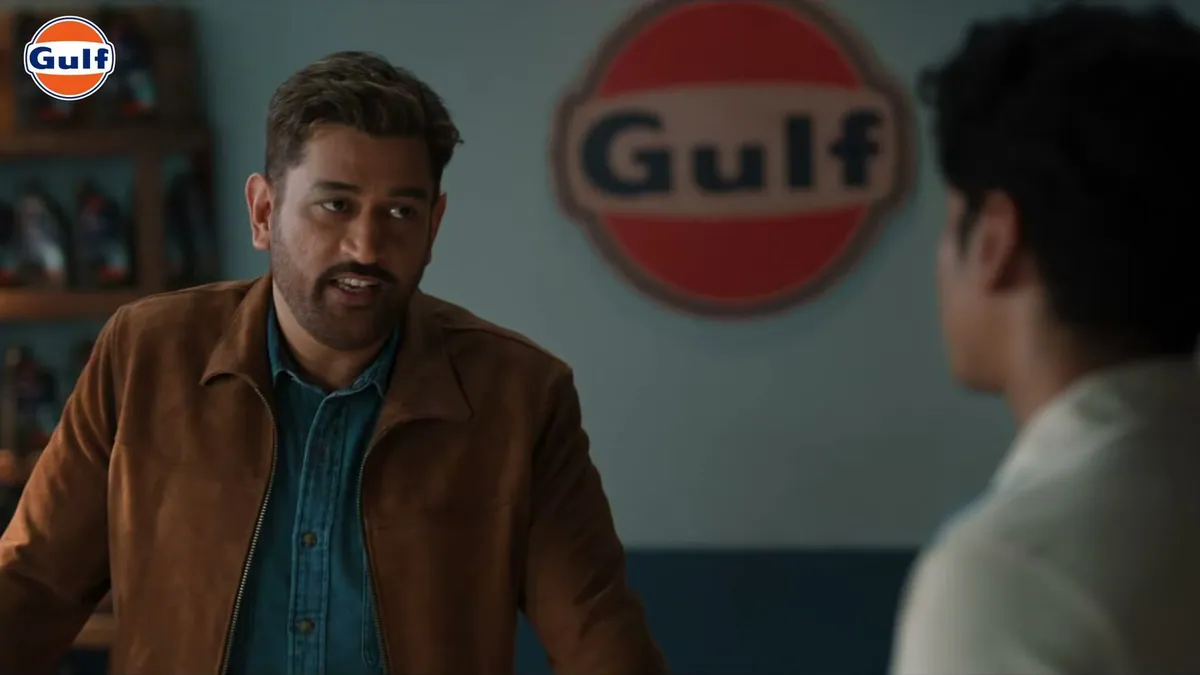 MS Dhoni talking to a young rider in a Gulf workshop, in a frame from the Kuch Behad Kar film
