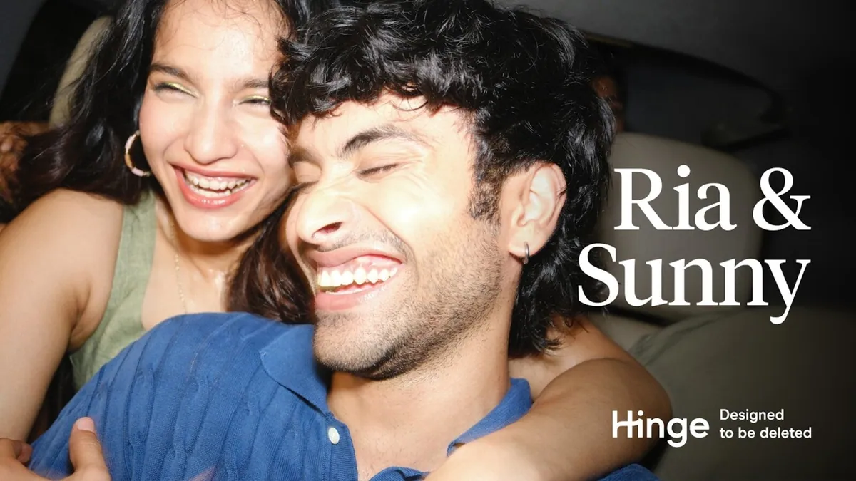 A couple laughing together in the back of a car, a frame from the Hinge India campaign film