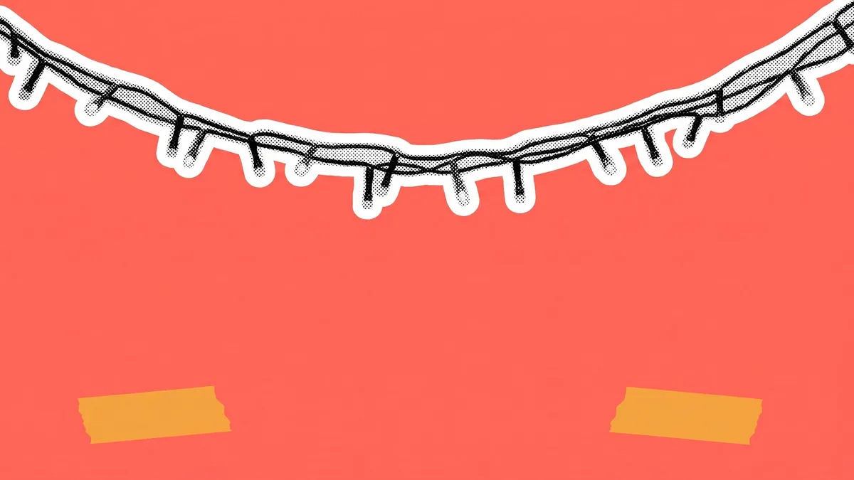 A string of festival lights swags across the top of a coral frame above open empty space