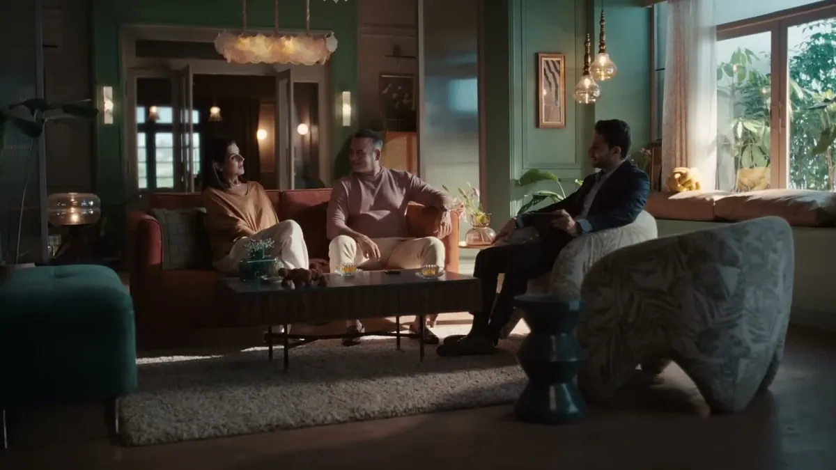 A still from the Ionic Wealth campaign film, showing a relationship manager in conversation with clients at home