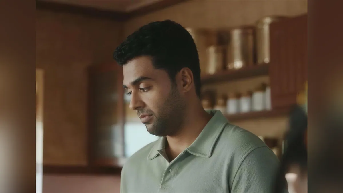 A still from the Lay's Hot Chips Style campaign film showing a man serving a meal in a home kitchen