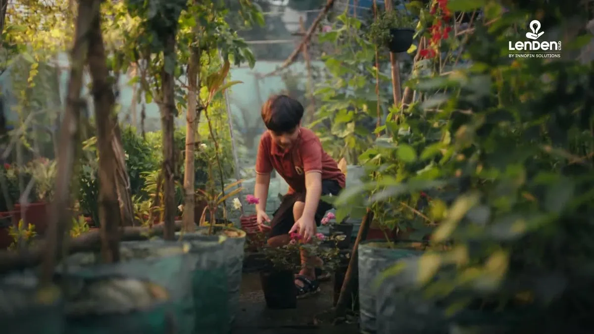 A still from LenDenClub's brand film The Seed, showing a boy tending the plant he has grown