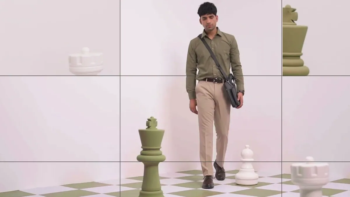 A man in an olive shirt walks between giant chess pieces on a green and white board, from the Liberty Shoes Chalo Apni Chaal film