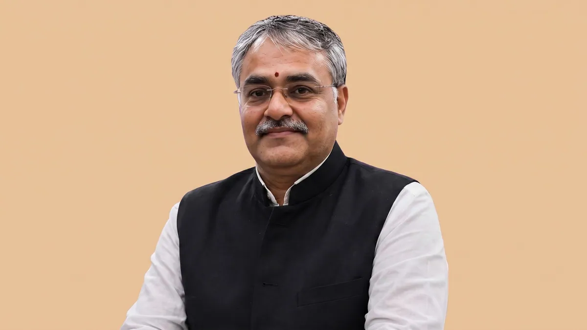 Mahendra Chaturvedi, senior vice president of sales at Lexlegis.ai, photographed against a flat warm sand background