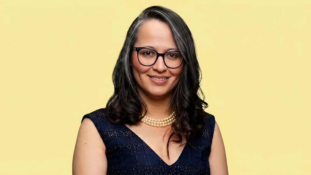 Purnima Lamba, chief brand officer at Mahindra Group, photographed against a flat butter yellow background