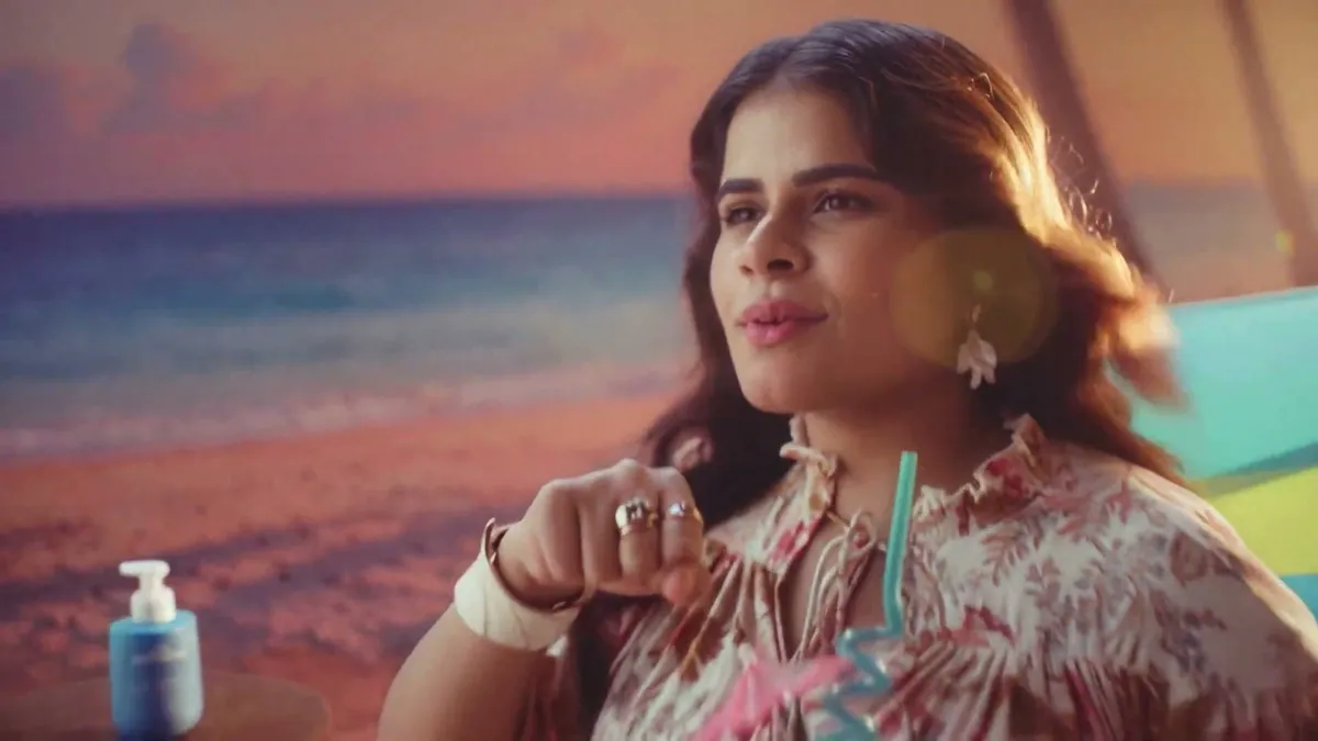 A police officer relocated to a Goa beach in a deck chair beside the lotion bottle, from mCaffeine’s By The Blues film