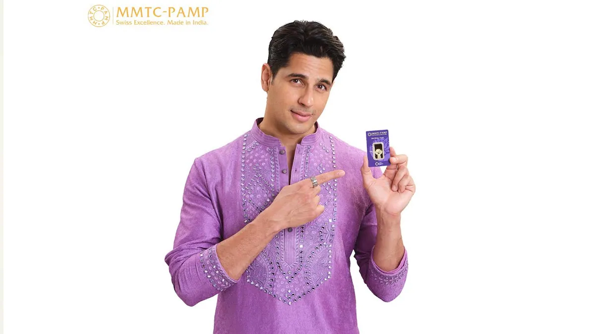 Sidharth Malhotra holding an MMTC-PAMP gold bar in the Purest And More campaign visual