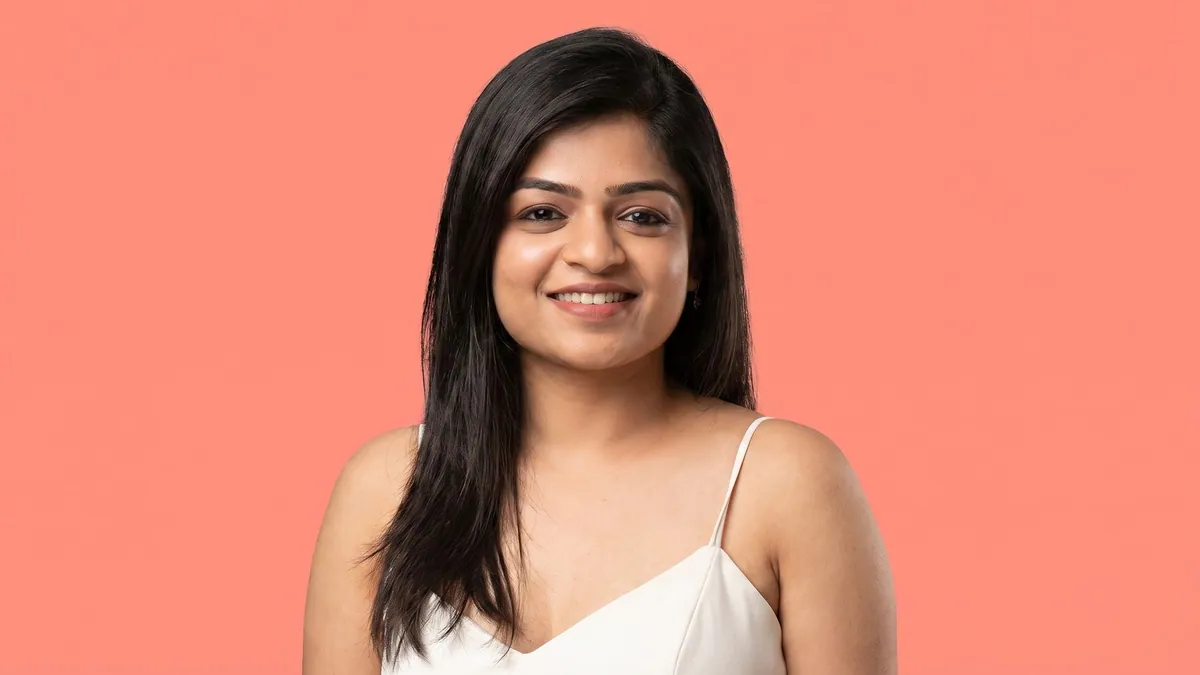 Priyanka Shah, group head at NDTV Digital, photographed against a flat coral background