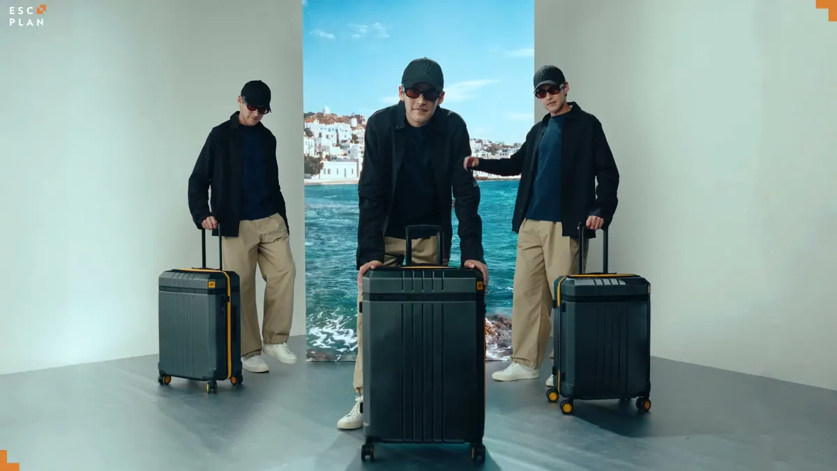 A suitcase and a folded shirt arranged like a fashion runway look
