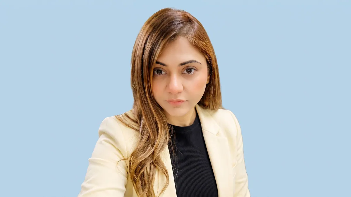 Sudha Wadhwa, national head of business growth at AdCounty Media, photographed against a flat powder blue background