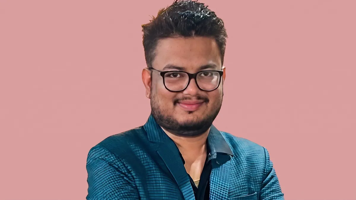 Umesh Khandelwal, general manager for media planning at OMD India, photographed against a flat dusty rose background