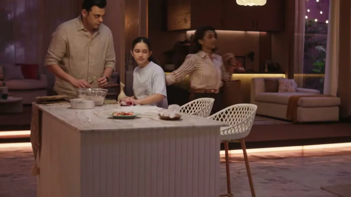 A family baking together at the kitchen island of a warmly lit home, from Whirlpool's Luxuriem campaign film