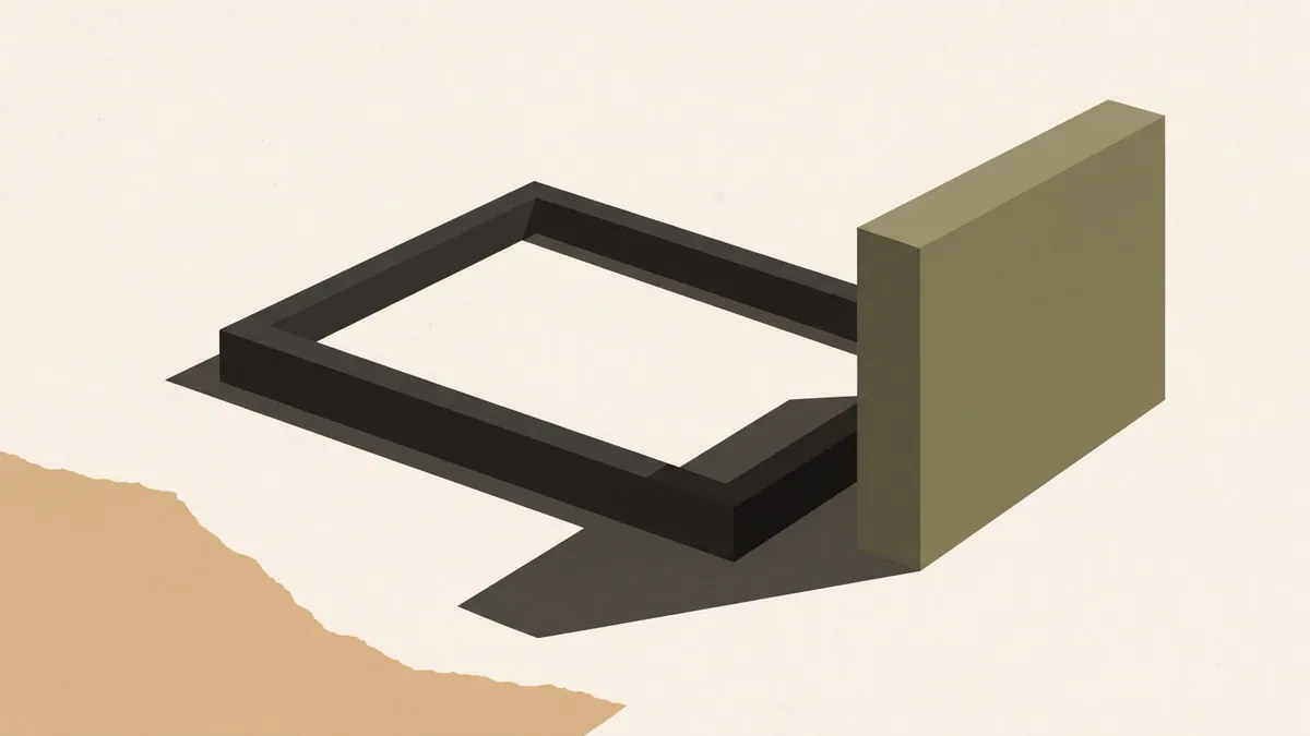 A picture frame lying flat on the floor while the image it once held stands upright beside it